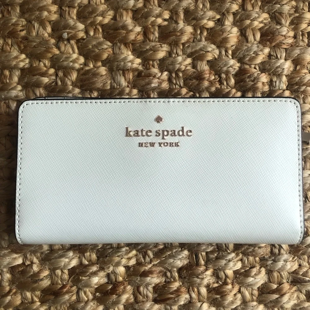 NWOT: Kate Spade Staci Slim Bifold Wallet. Saffiano Leather. Color is Parchment.